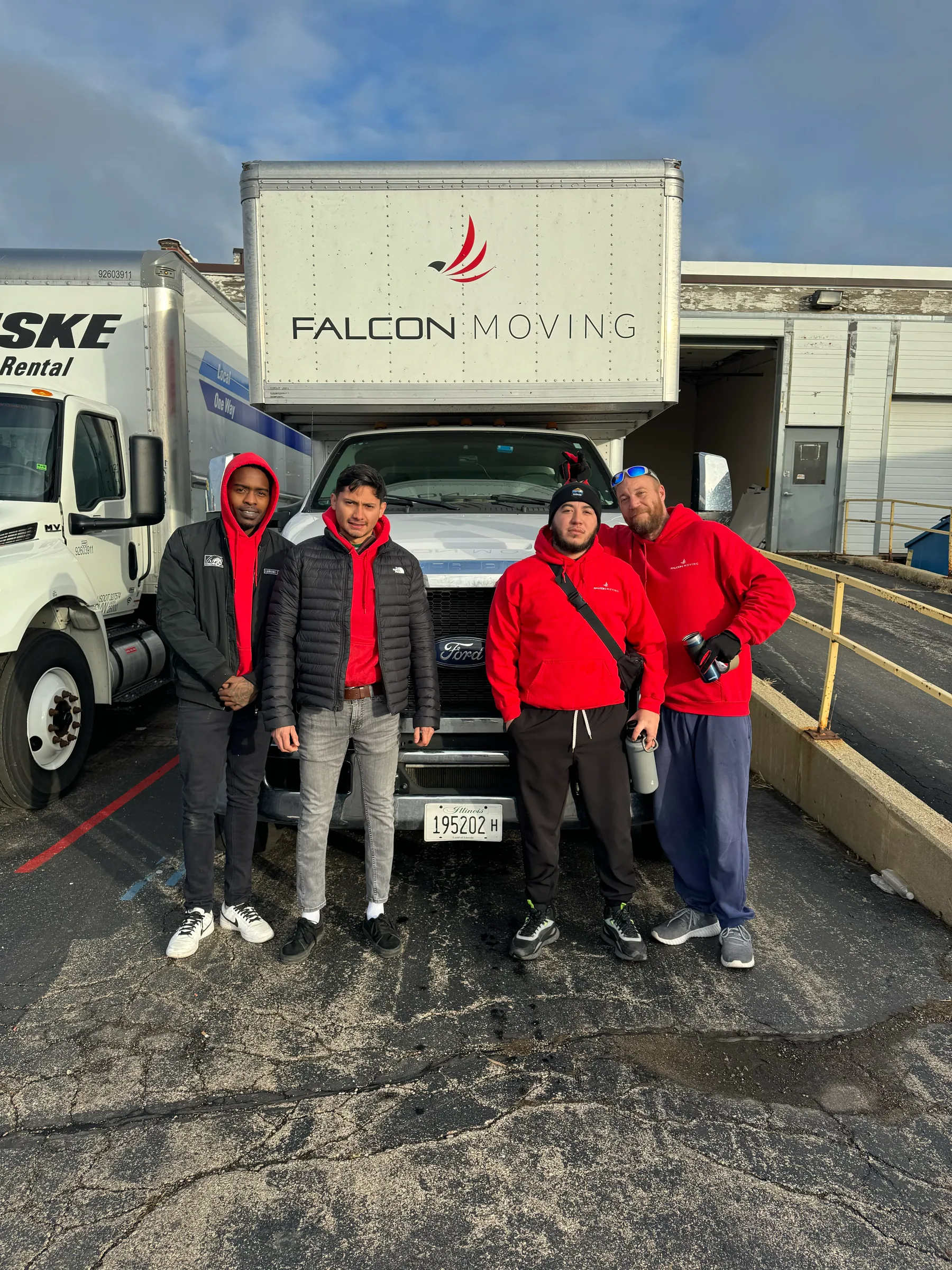 Falcon Moving crew standing near a branded moving truck